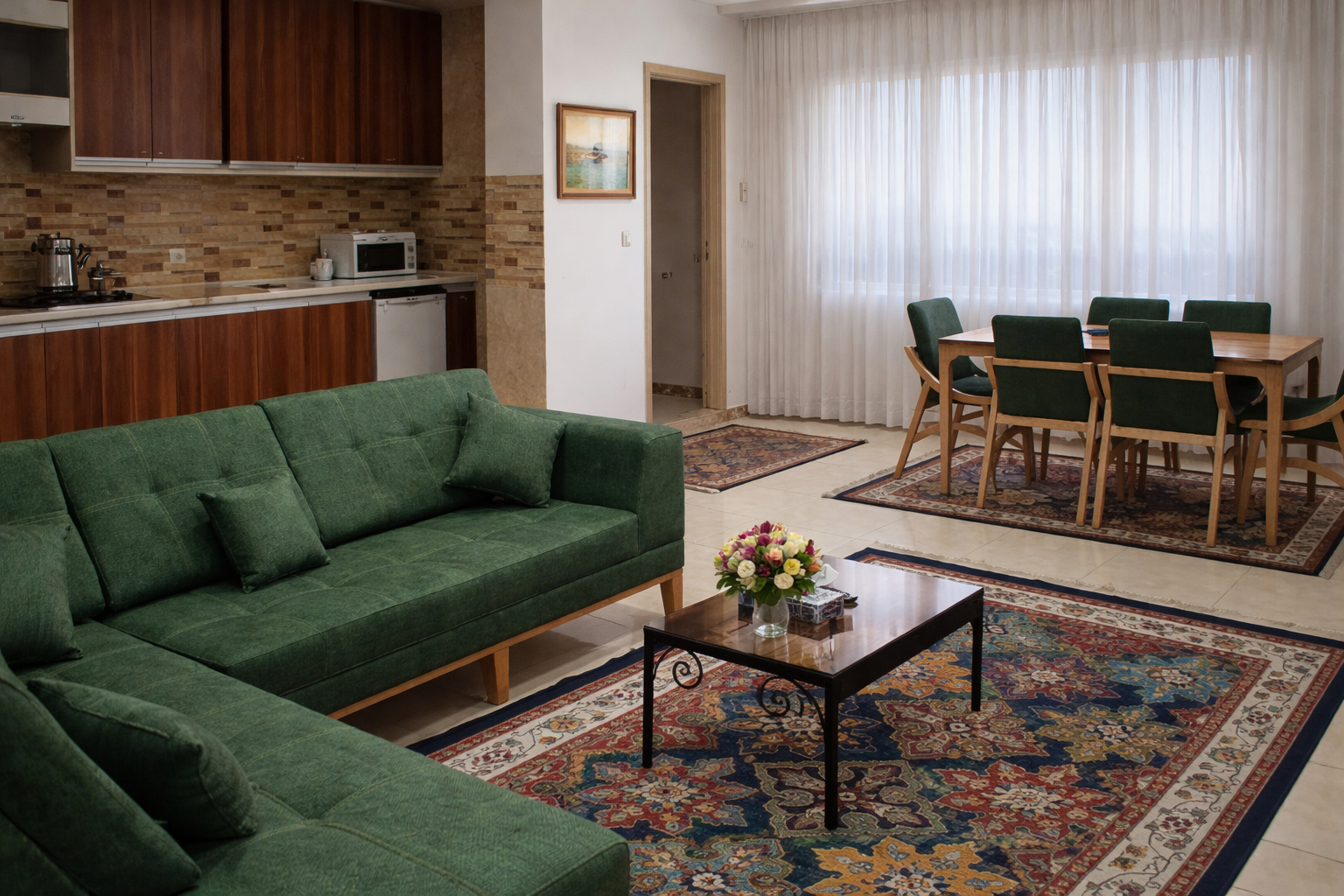 Living room with green sofa and dining area